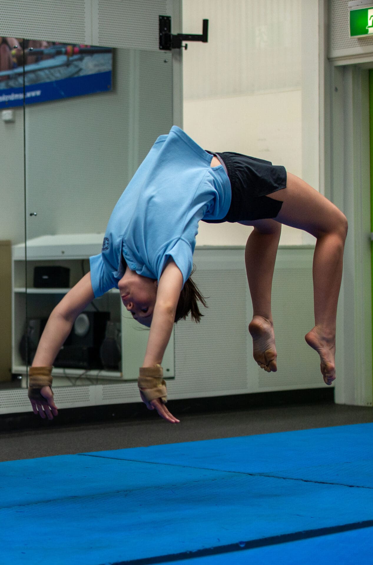 student performing a backflip