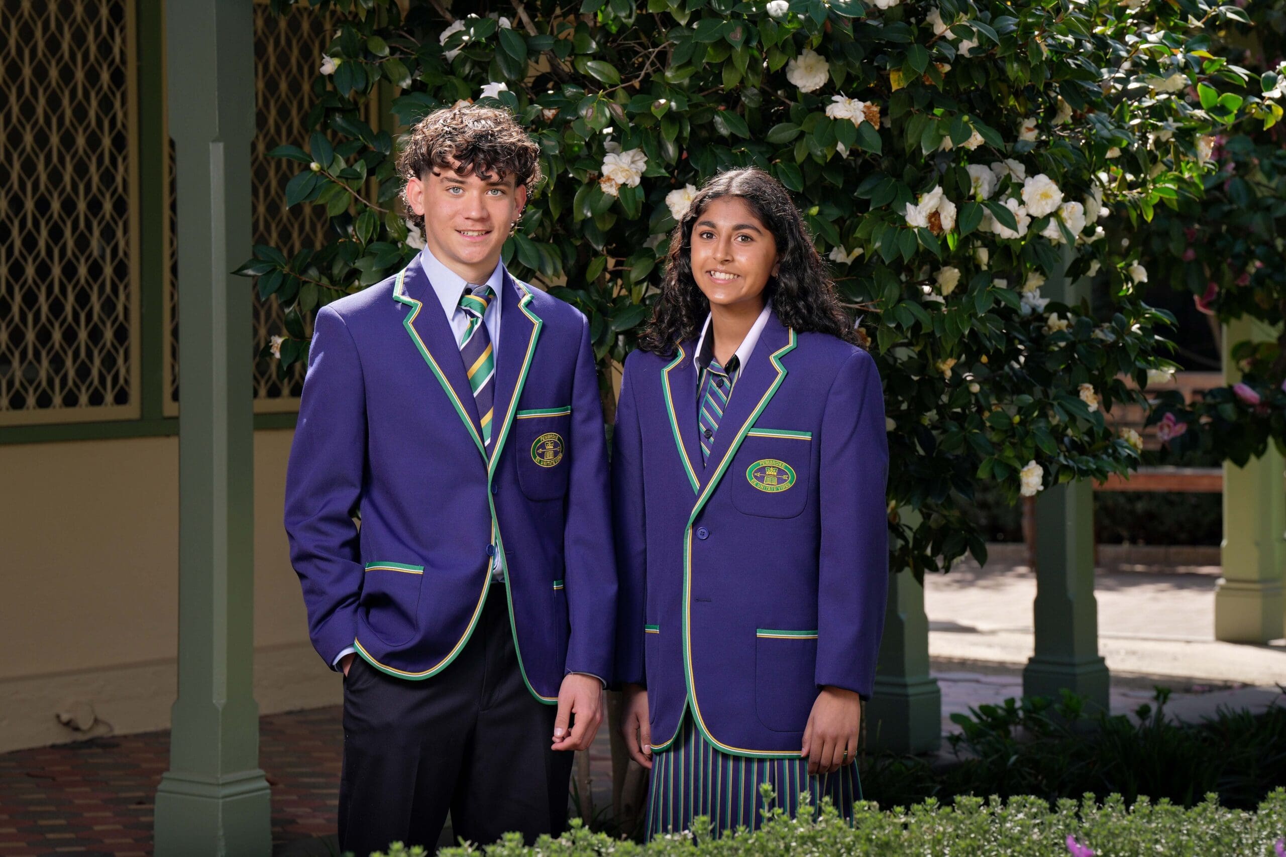 two students in the academic uniform
