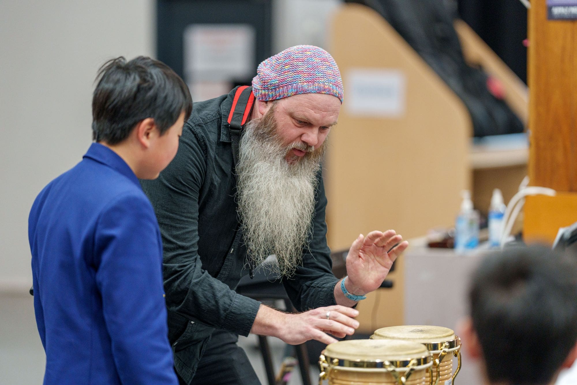 Artist in Residence, Adam Page, working with a student on percussion before the 2026 Music Showcase.