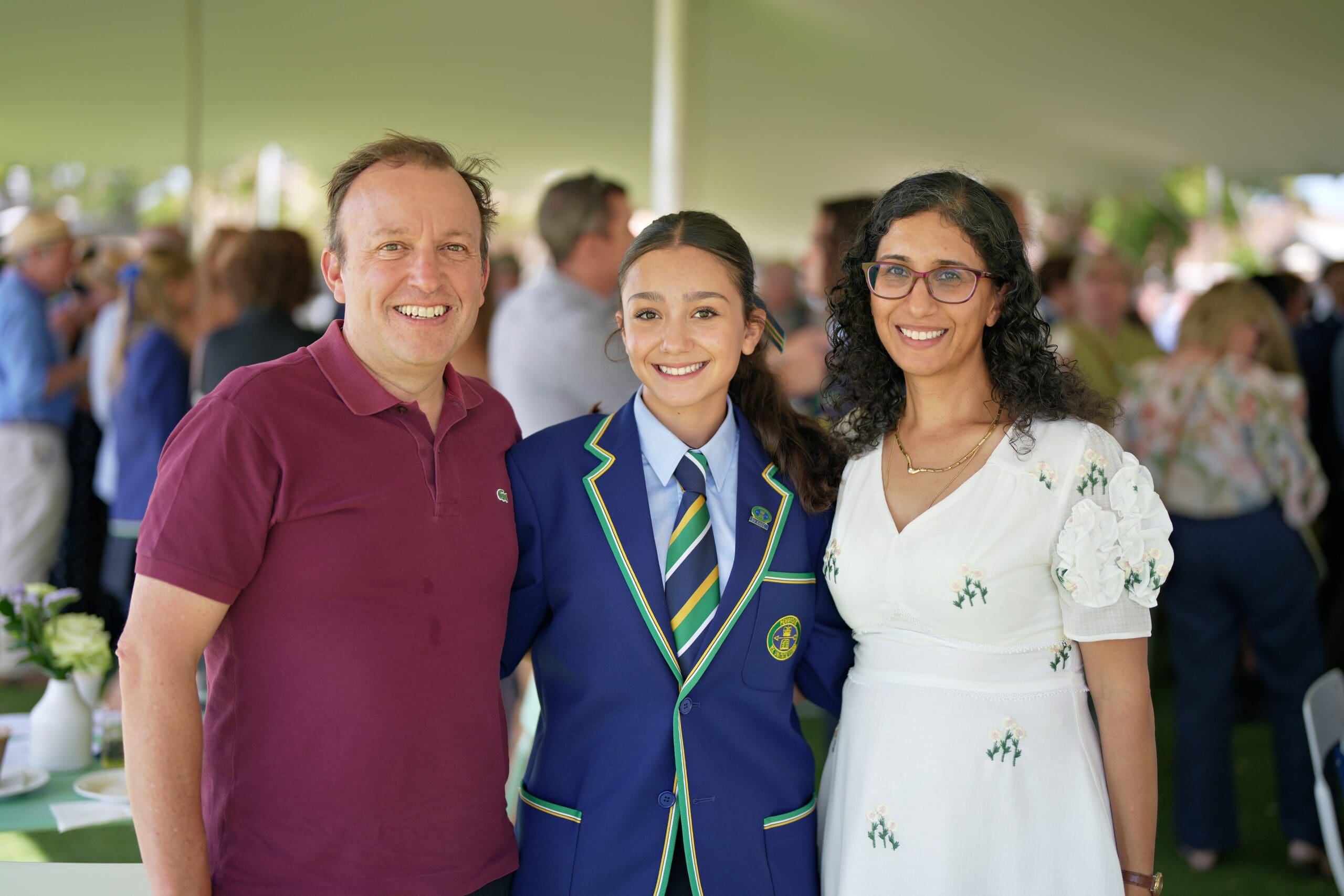 student leader with parents at commencement of year ceremony
