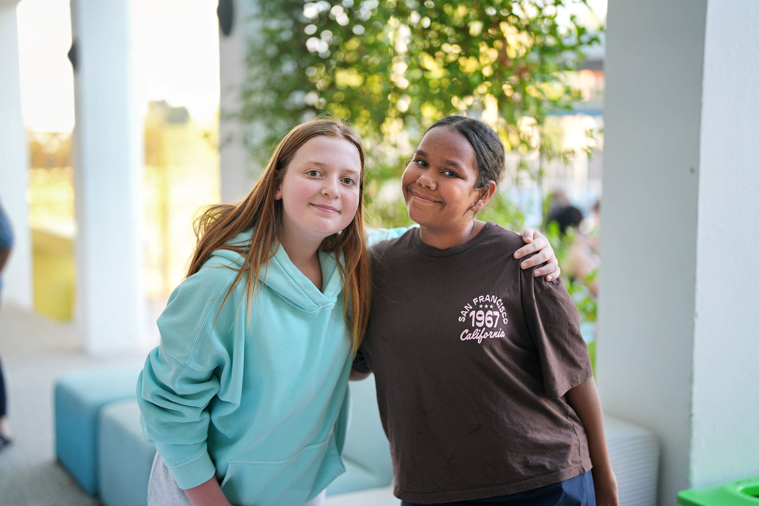 two boarding students smiling together at a bbq event