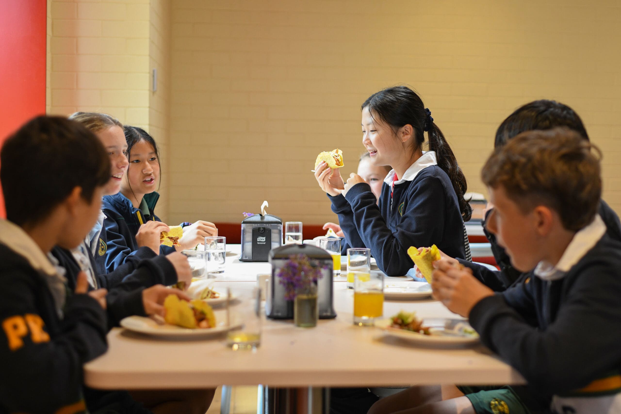 junior school students enjoying lunch in john moody dining room