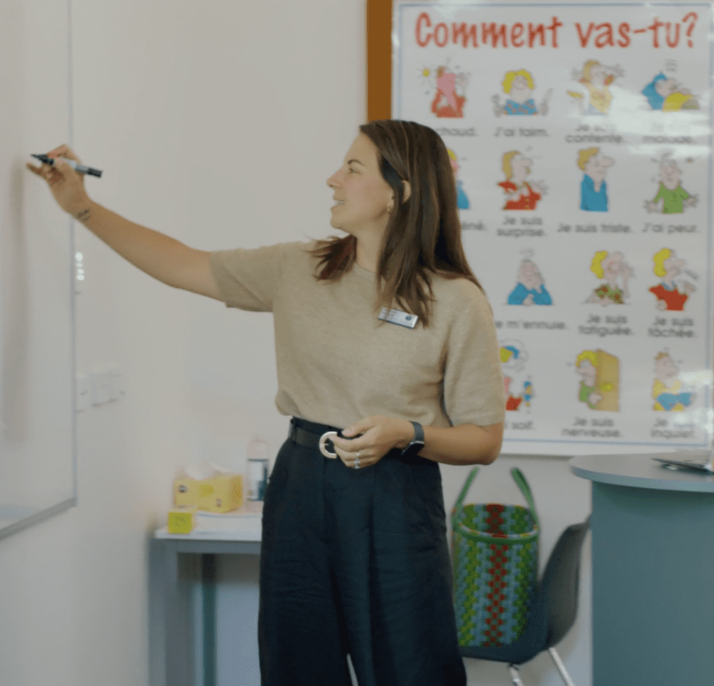 French Language Coordinator & Semi-Immersion Leader 2024 drawing on whiteboard in classroom