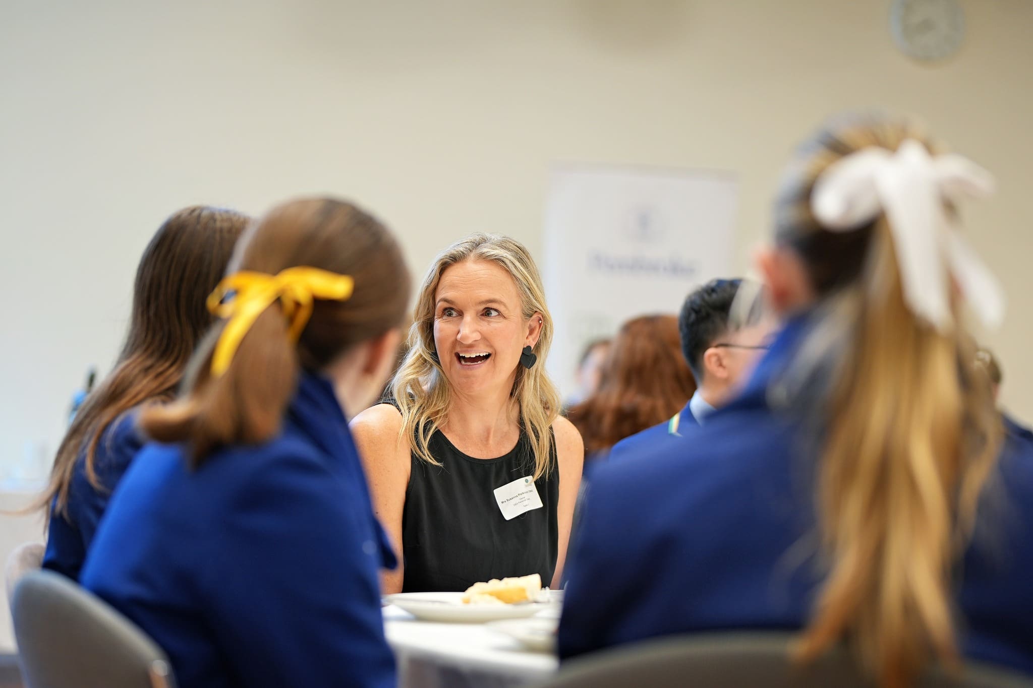 Old scholar mentor with students at table at Careers Breakfast 2026 v2