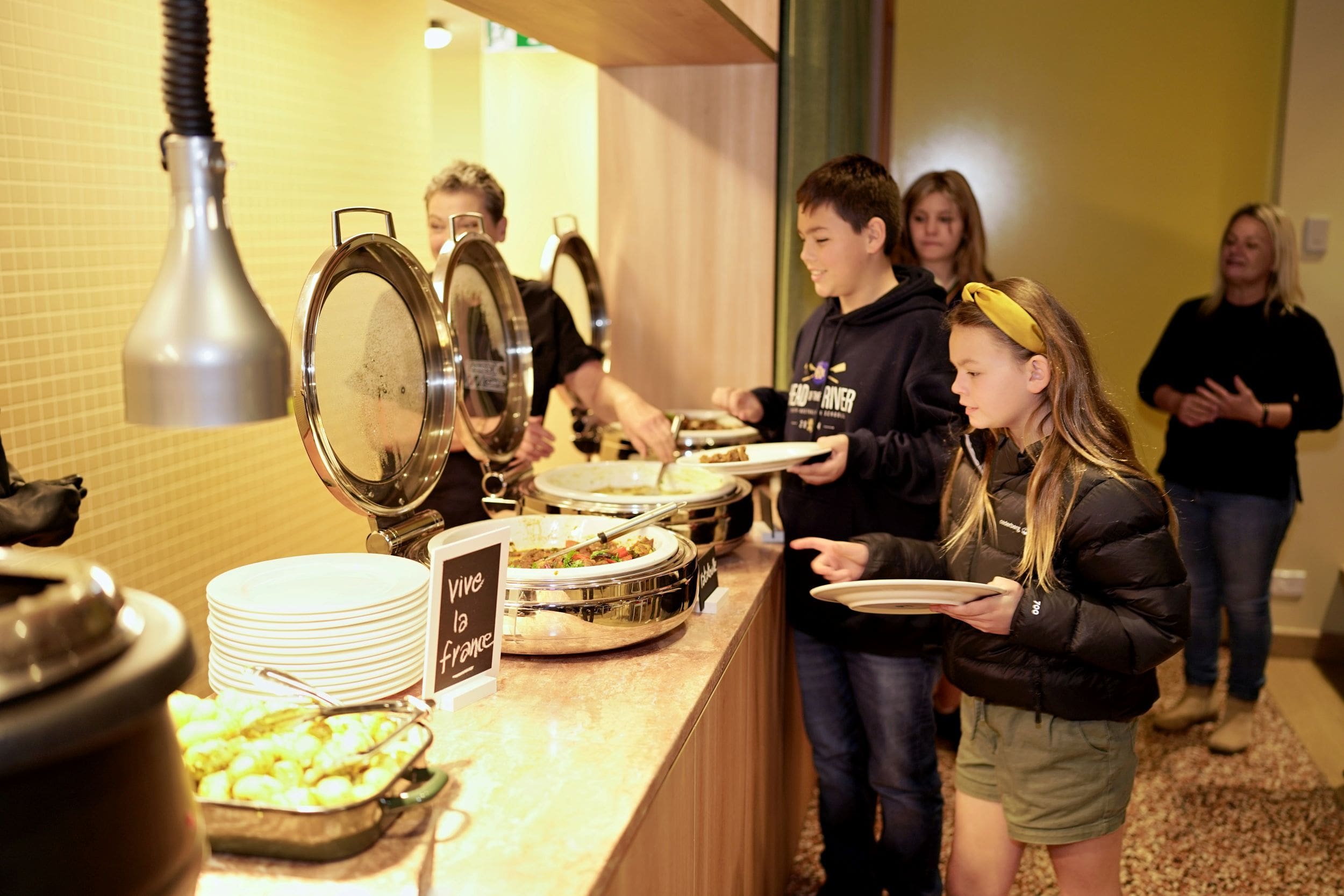 boarding students serving themselves food in the dining room