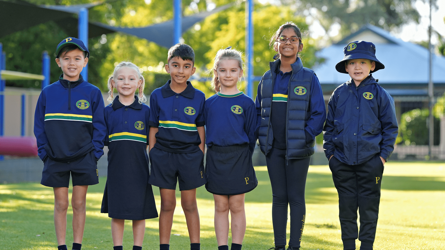 six junior school students posing in new play based uniform