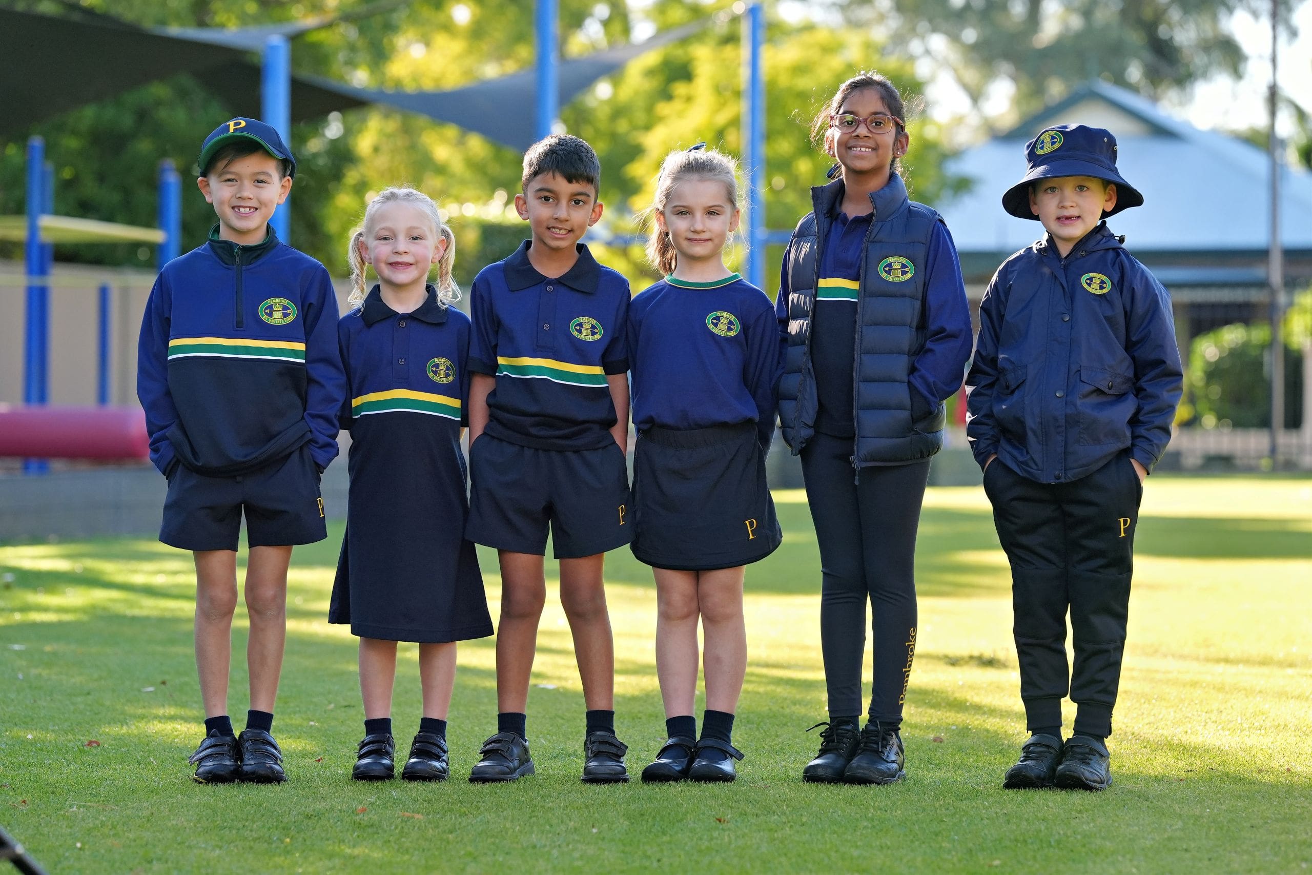 six junior school students posing in new play based uniform