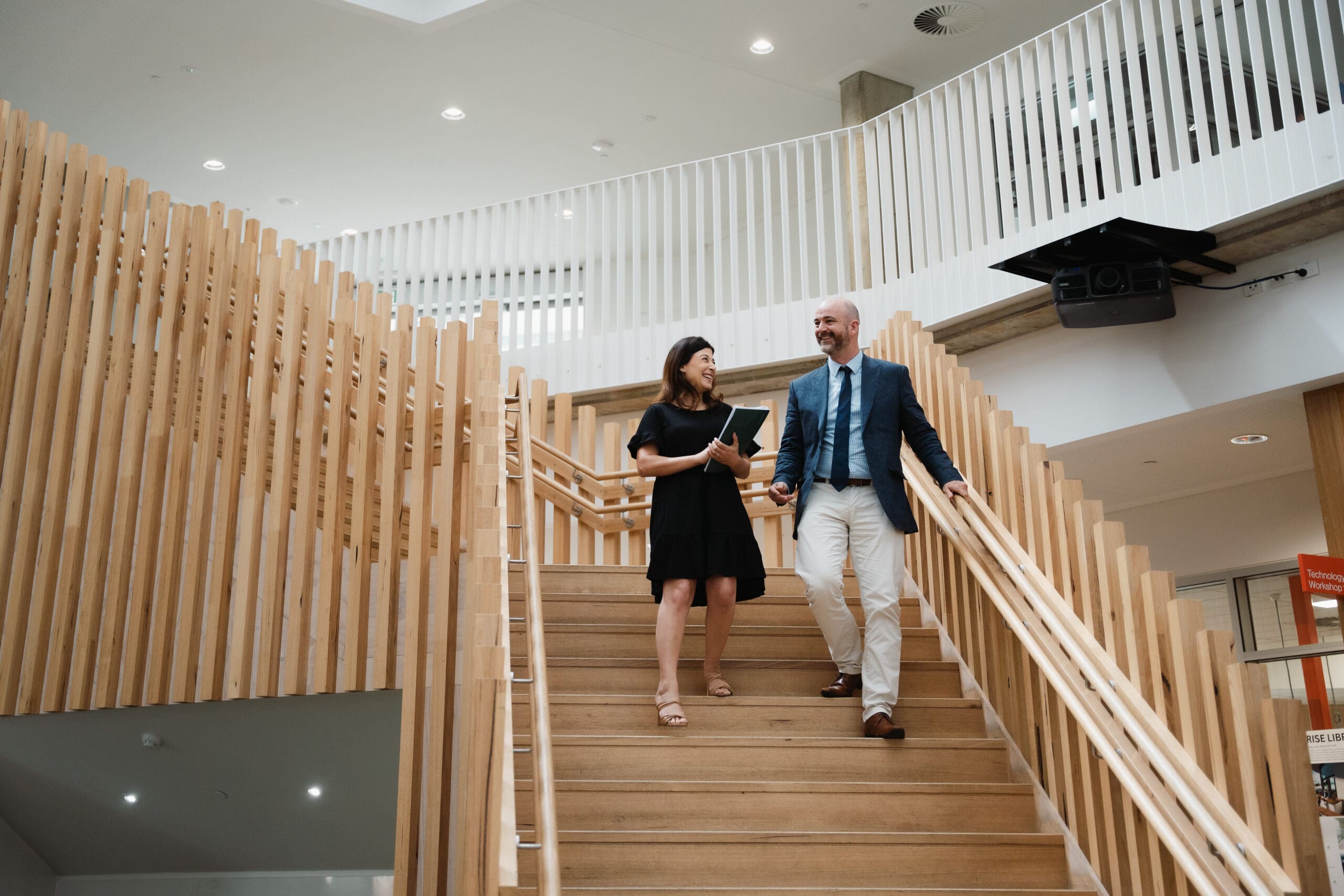 two staff members walking and talking